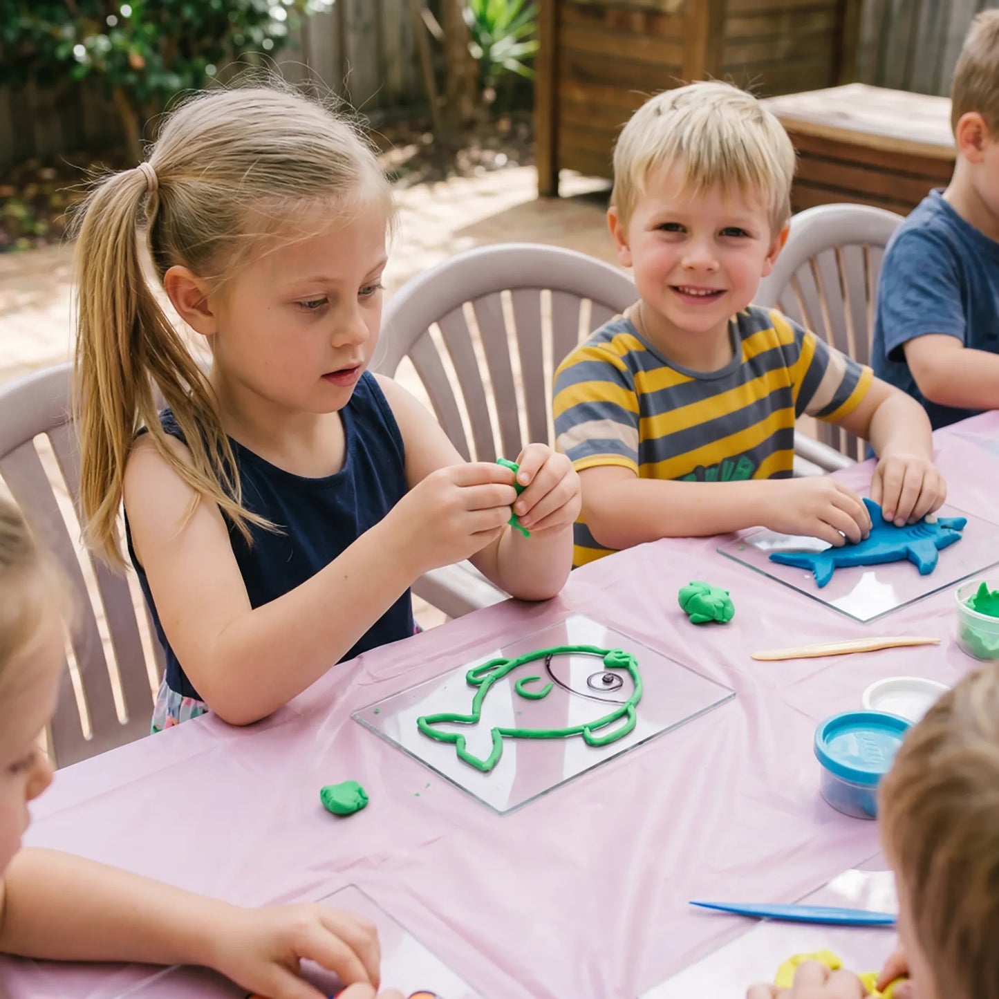 Kids creating clay animal art in an outdoor art class setting during a mobile children’s workshop in Los Angeles.