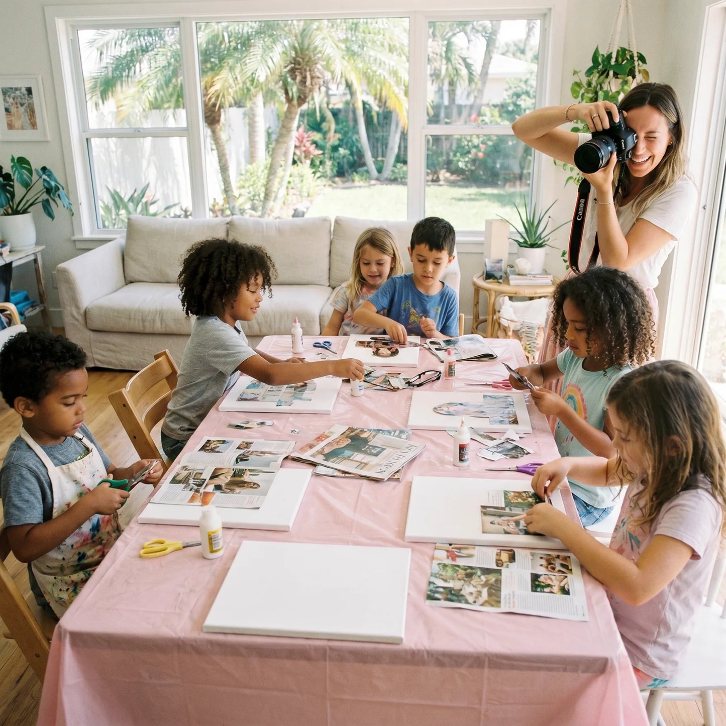 Children selecting colorful papers and cutouts during a mobile collage art party in Los Angeles